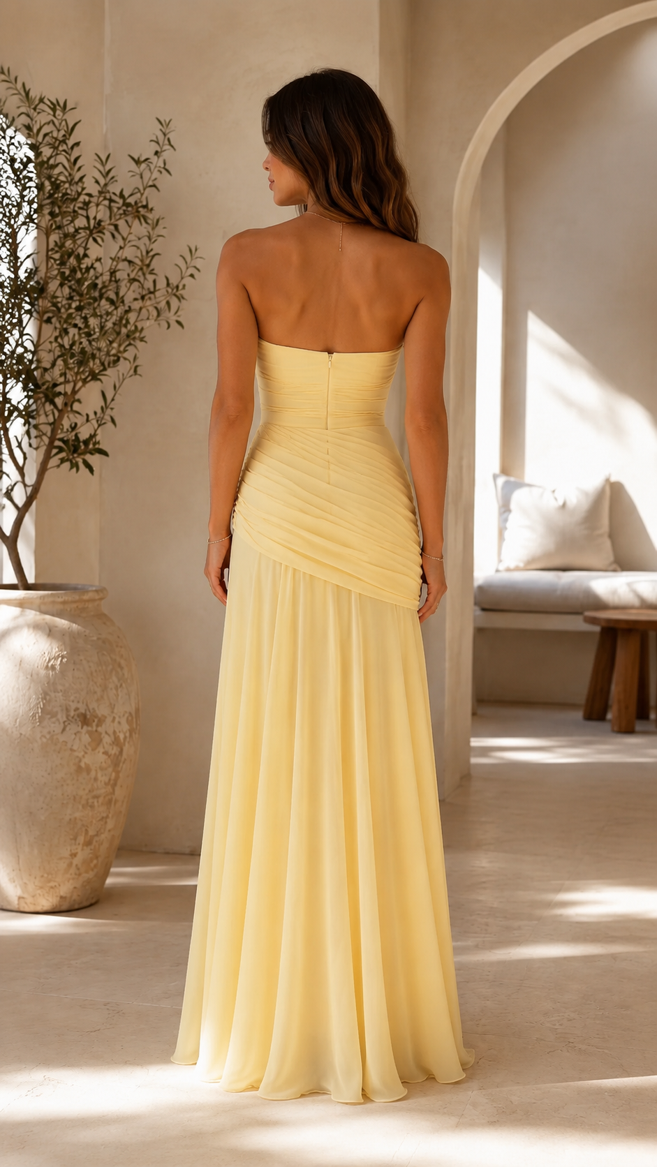 Back view of butter yellow strapless ruched maxi dress with concealed zipper