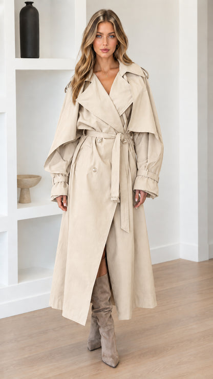 Full-length view of woman wearing Beige cream belted long trench coat